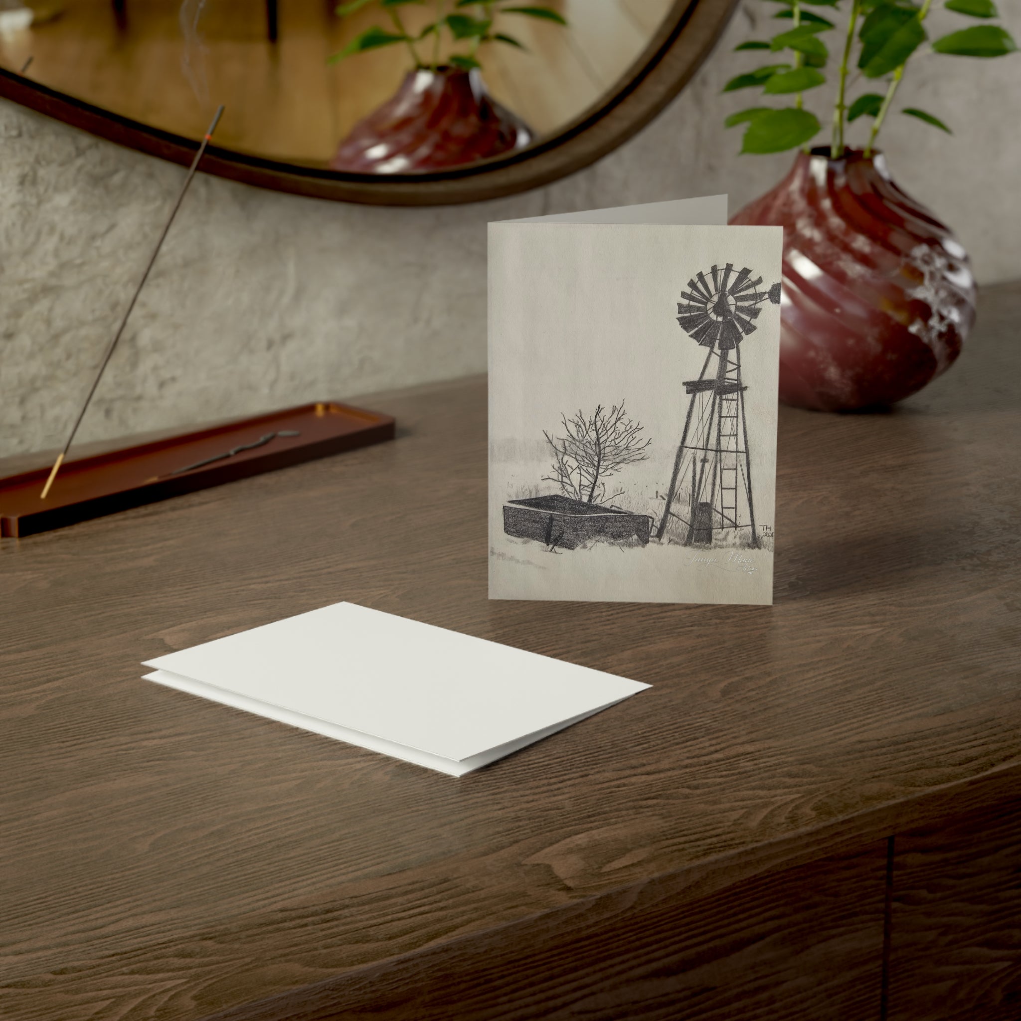 White greeting card front showing a windmill, tree, and shed sketch, rectangular