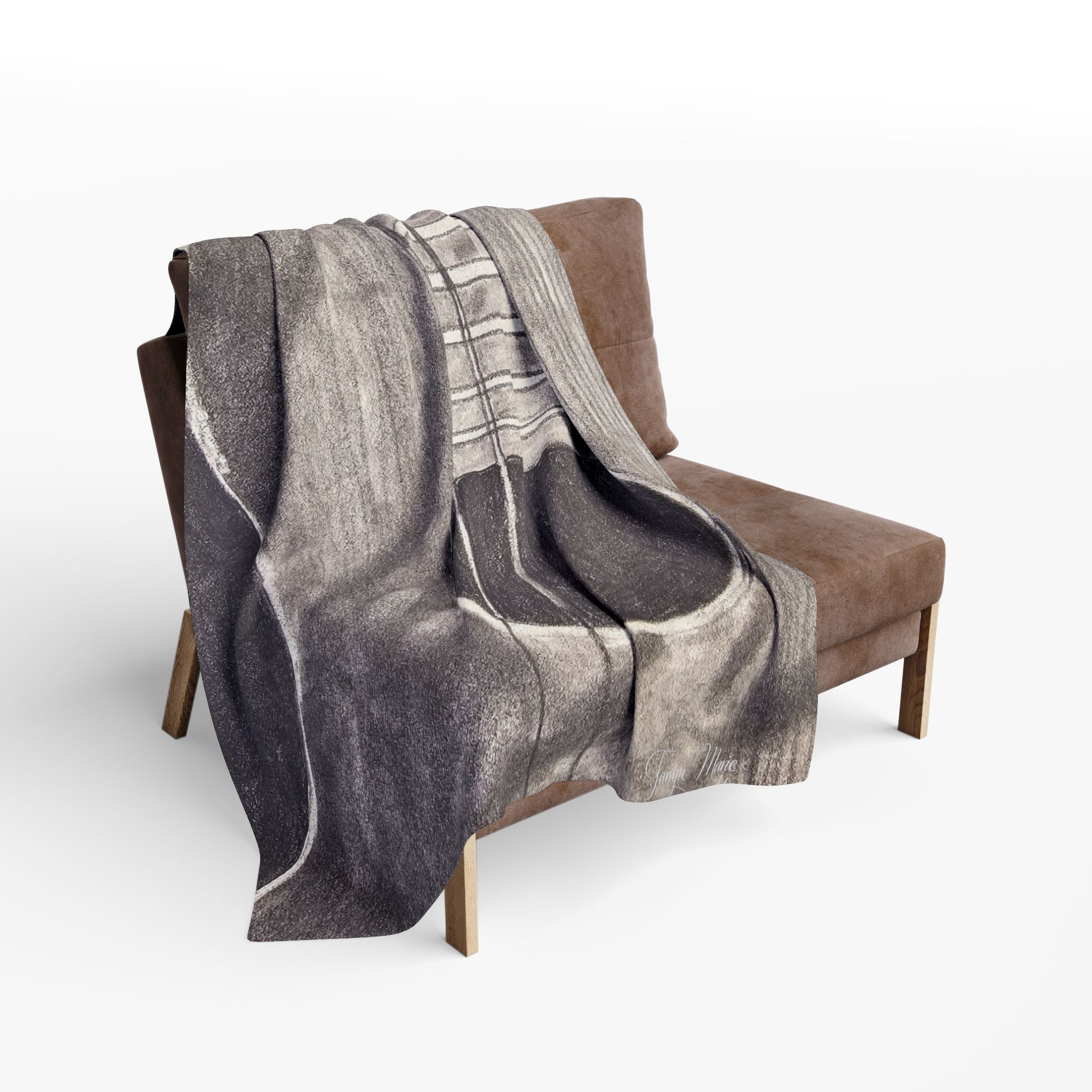 Gray fleece blanket with acoustic guitar sketch, draped over chair