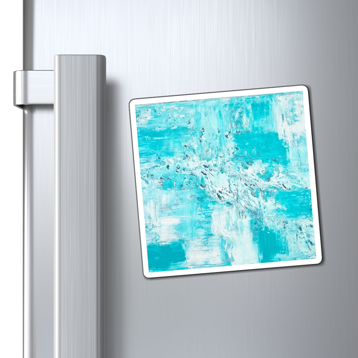 Ocean-blue abstract art magnet displayed on silver refrigerator door, teal and white splash