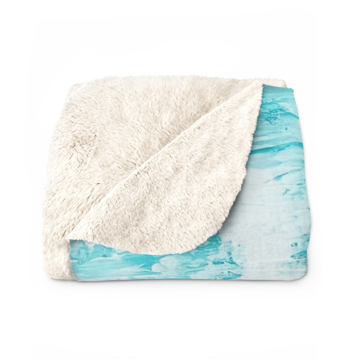 Folded sherpa blanket showing off-white fluffy side over turquoise abstract pattern