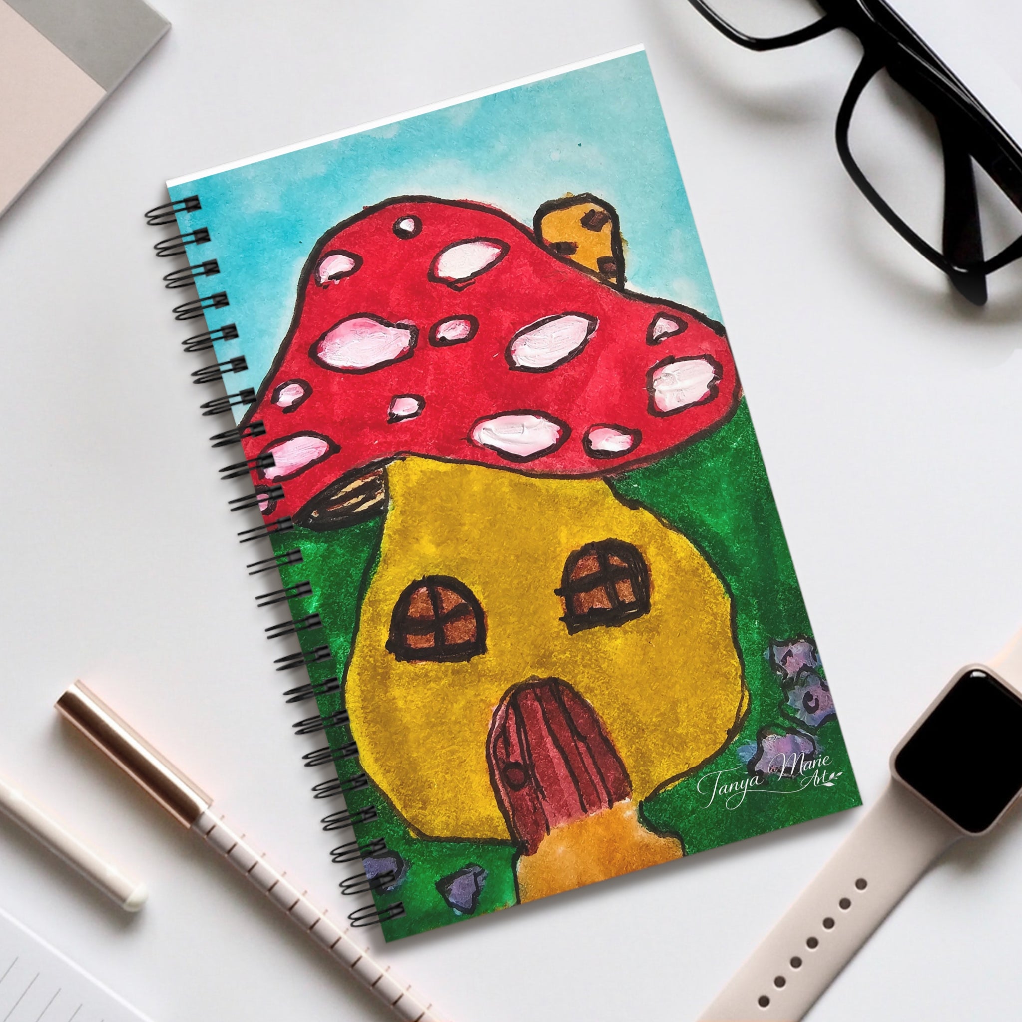 Spiral notebook with red mushroom cottage cover art and black coil binding