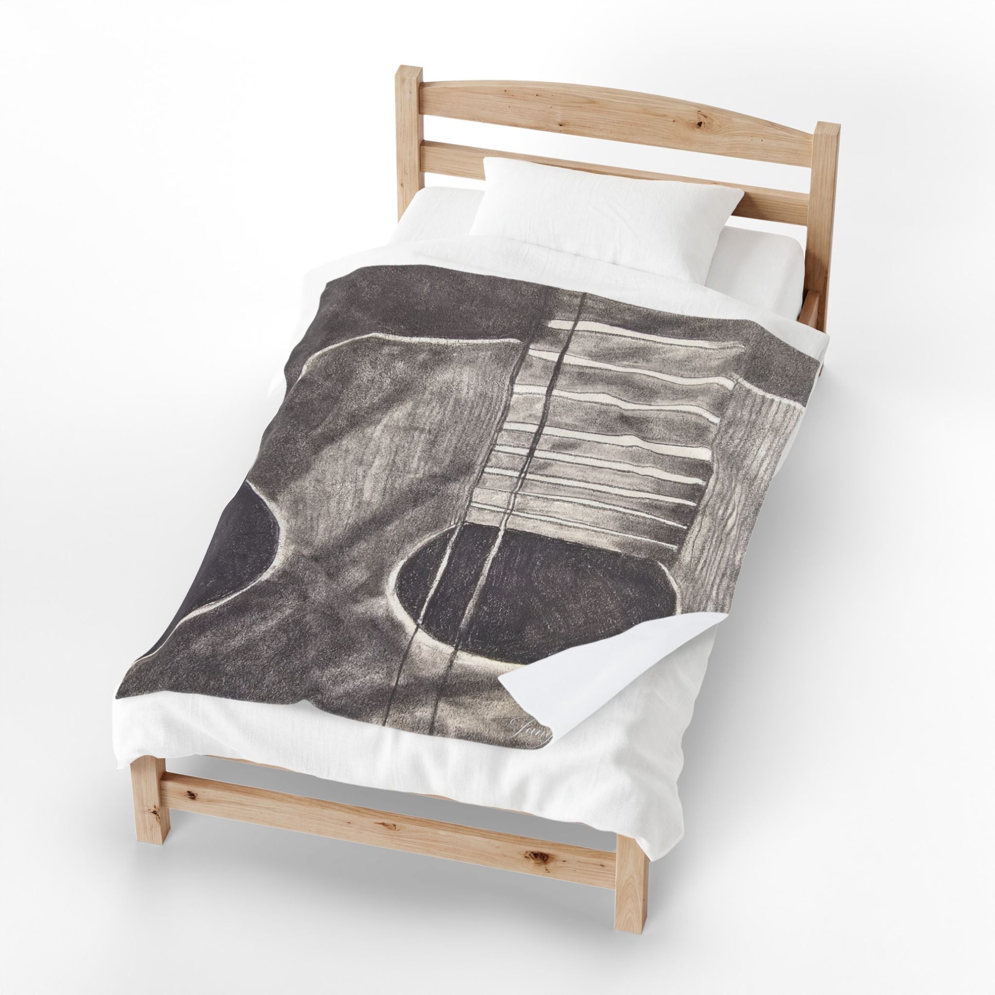 Velveteen plush blanket draped on bed, featuring gray guitar outline with white string lines