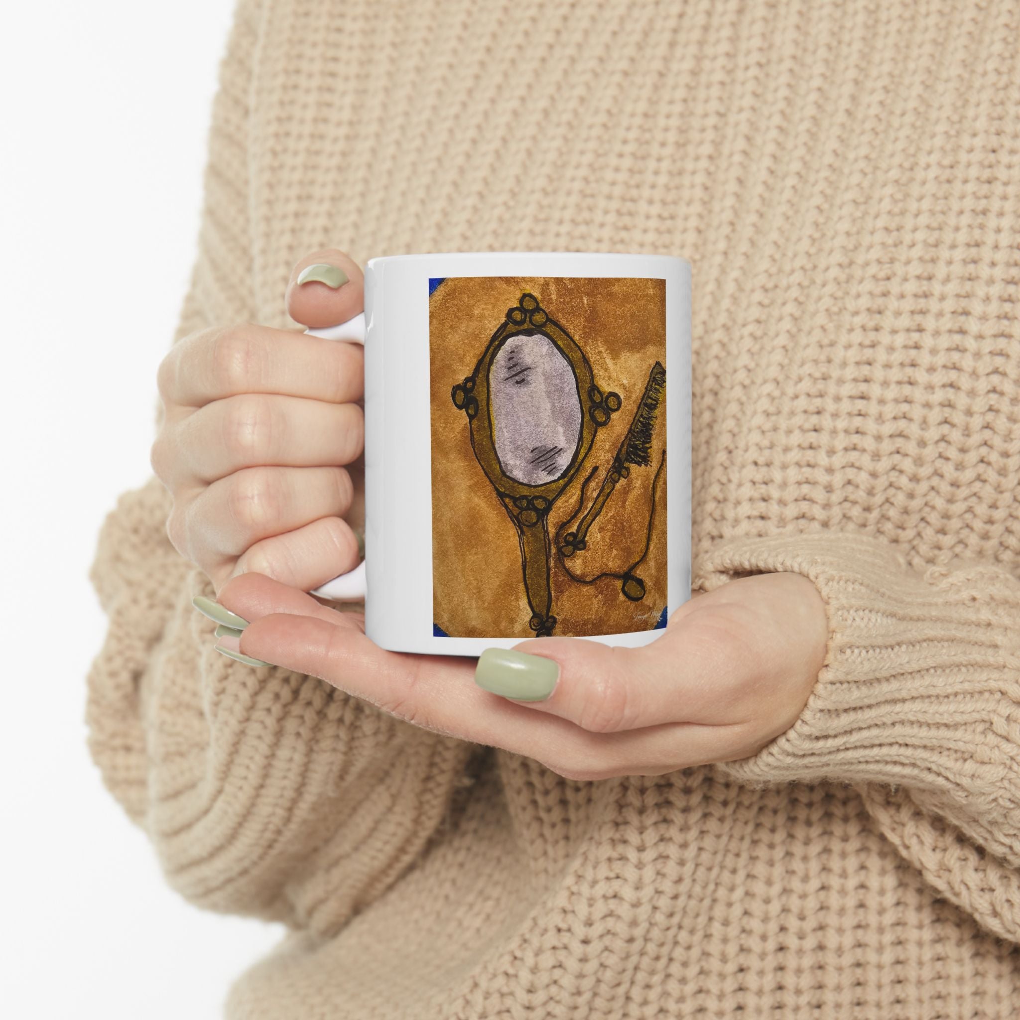 Ceramic coffee mug with vanity mirror artwork, held in two hands