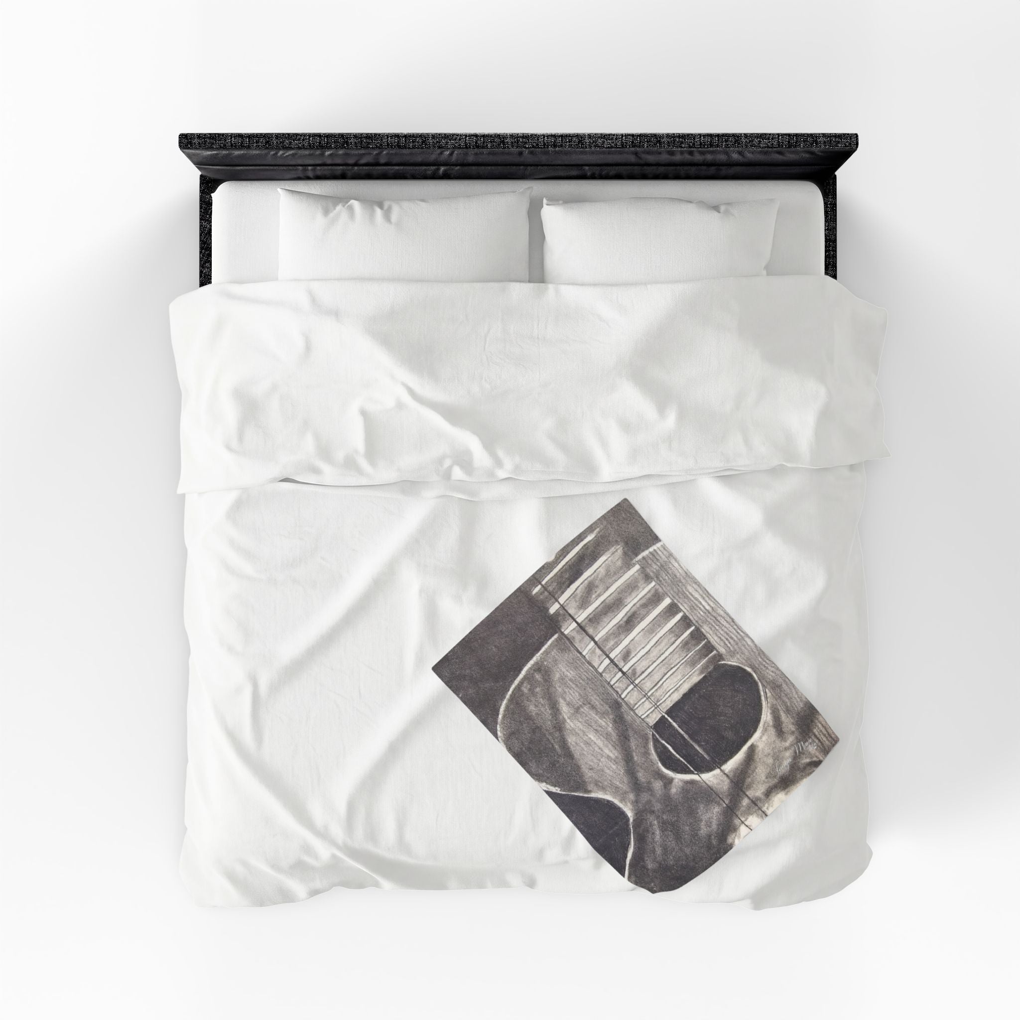 Plush blanket with acoustic guitar sketch graphic in dark gray on white bedding