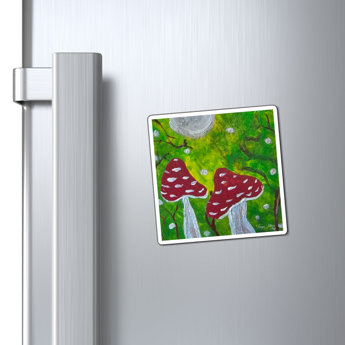 Hand-painted toadstool art magnet with red mushrooms under a gray moon on a fridge