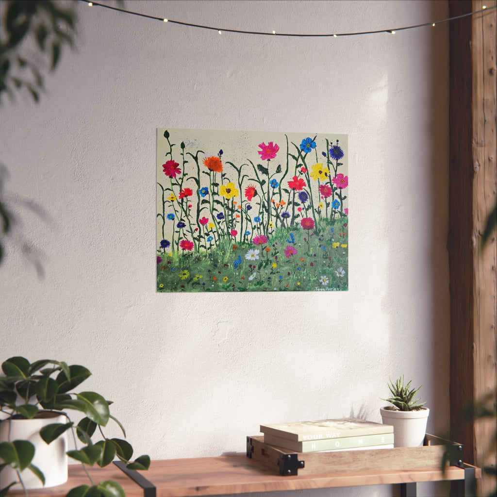 Matte floral meadow art poster on wall above wooden table with books and small plant