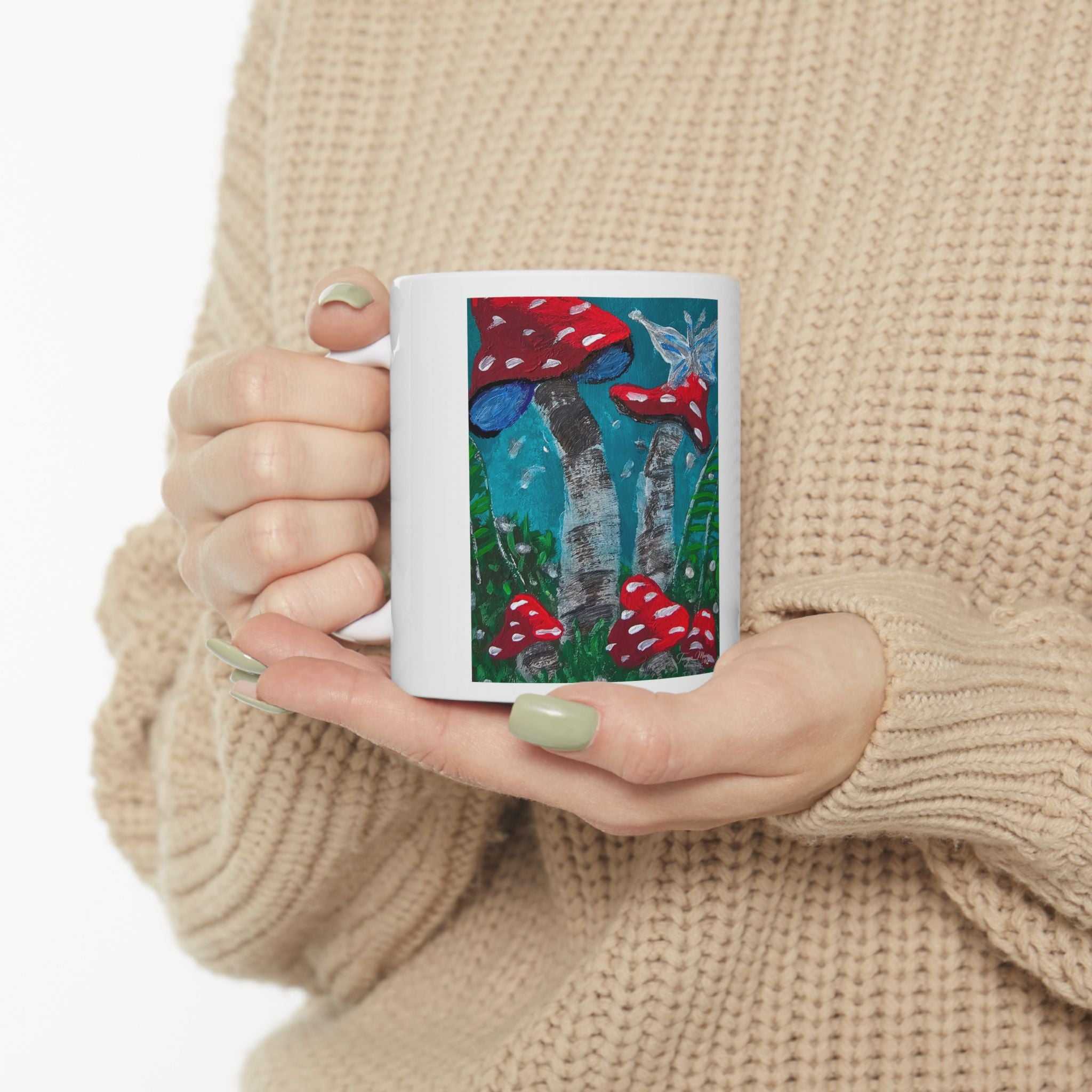 Ceramic mug with red mushroom garden illustration, held in hands