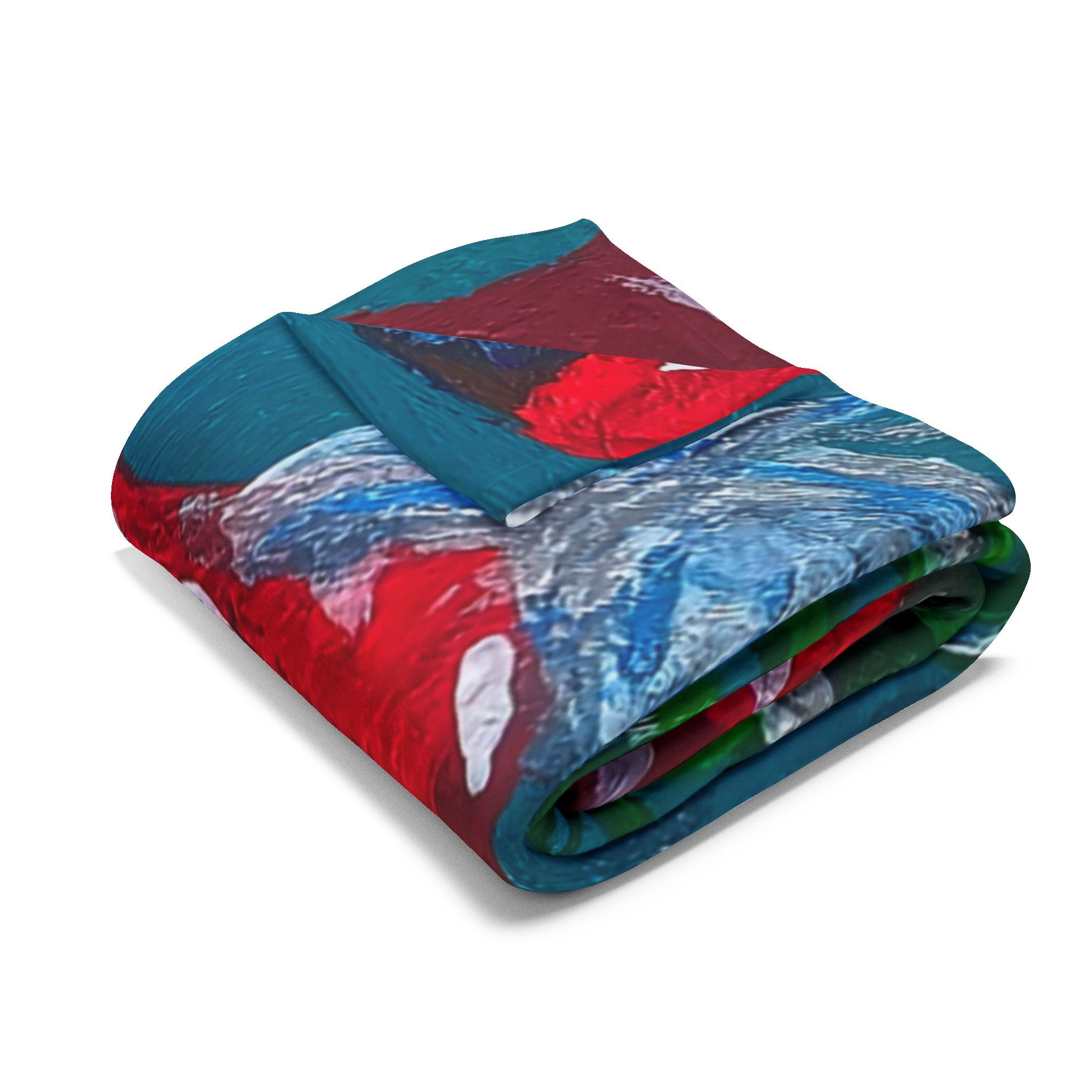 Fleece blanket with teal, blue, and red mushroom pattern, folded and layered edges