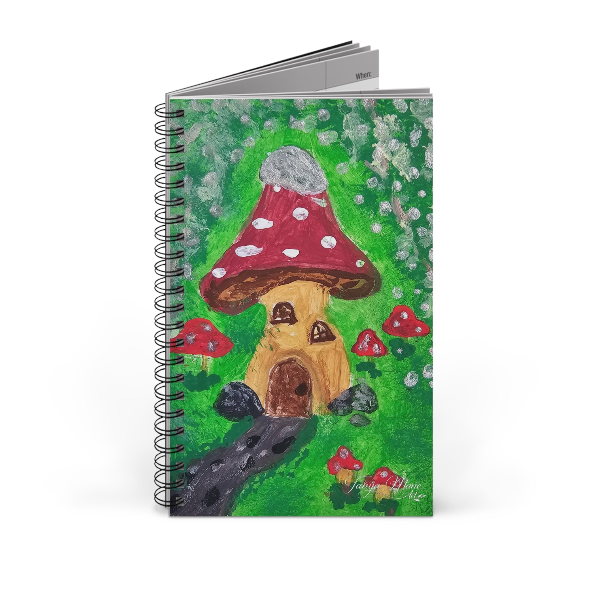 Spiral notebook stack with whimsical mushroom house illustration on a green cover
