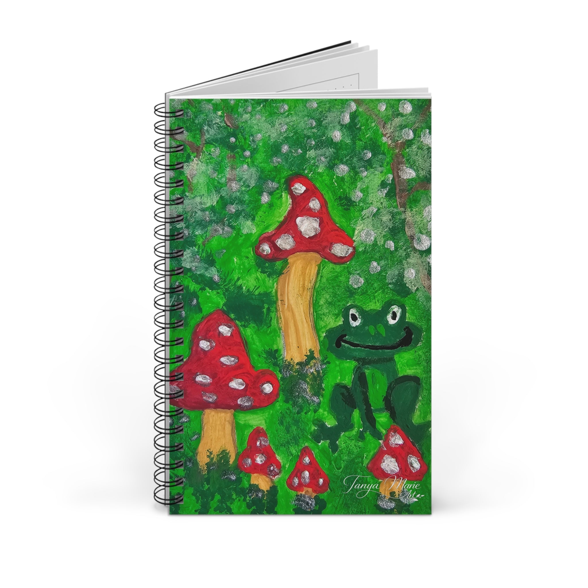Spiral journal front cover with green forest scene, red mushrooms, and frog illustration.