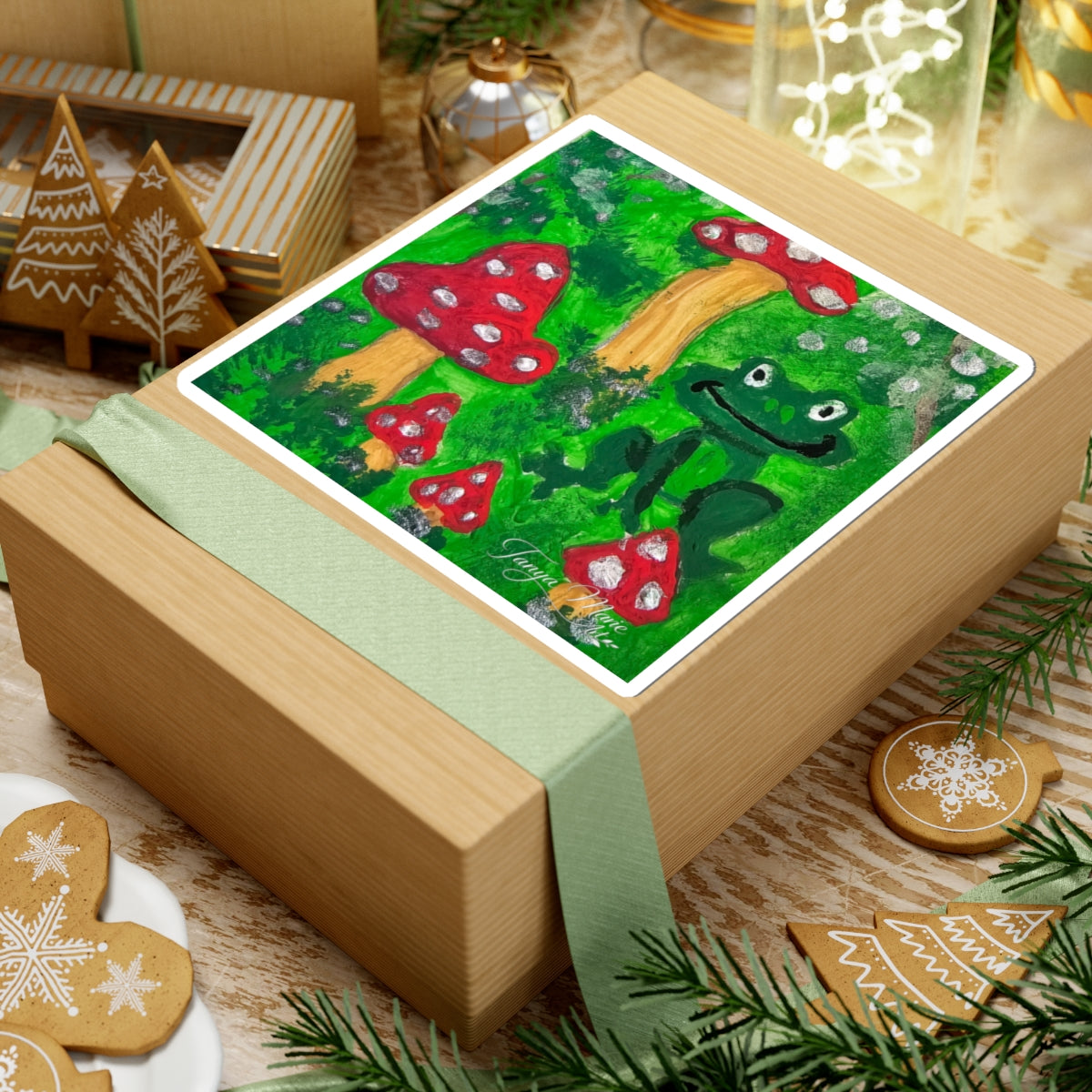 Kiss-cut garden sticker with green frog and red toadstools, white outline frame