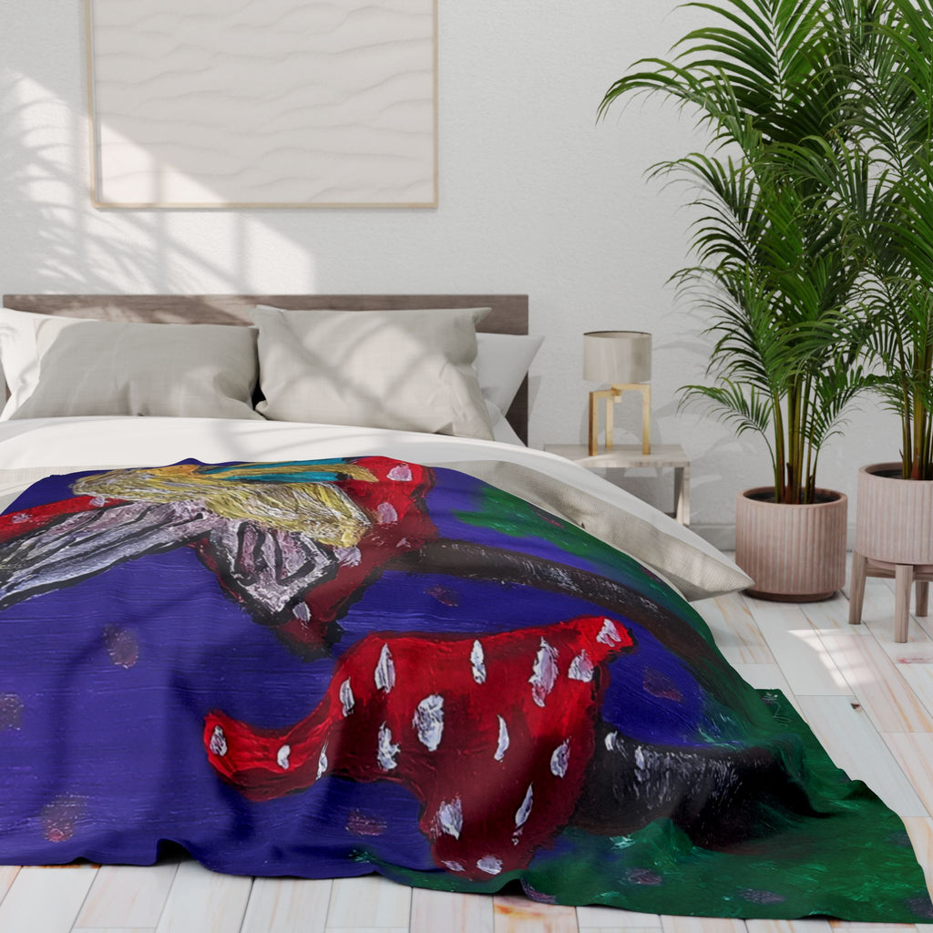 Fleece blanket with colorful mushroom-and-fairy artwork in blue, red, and green