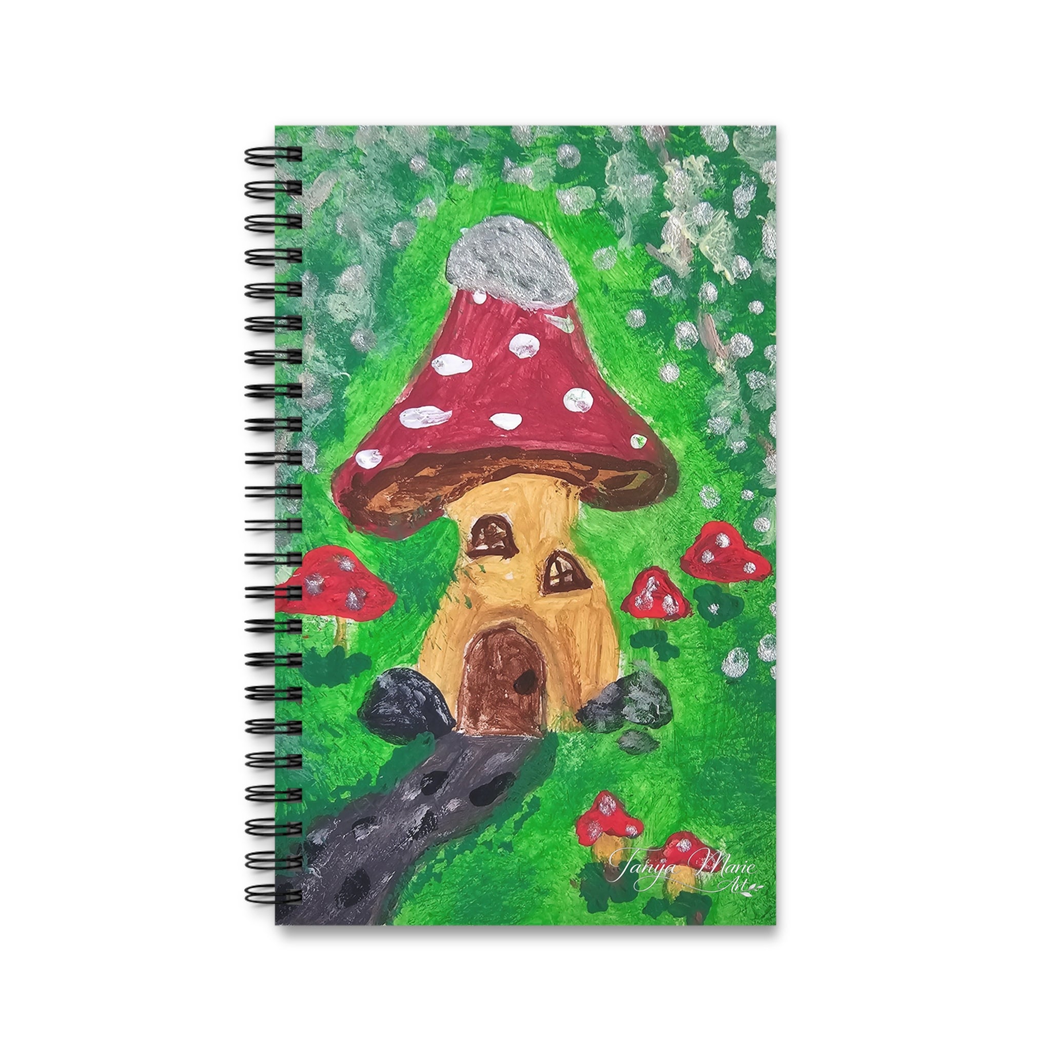 Front spiral notebook with painted mushroom house illustration on a green cover