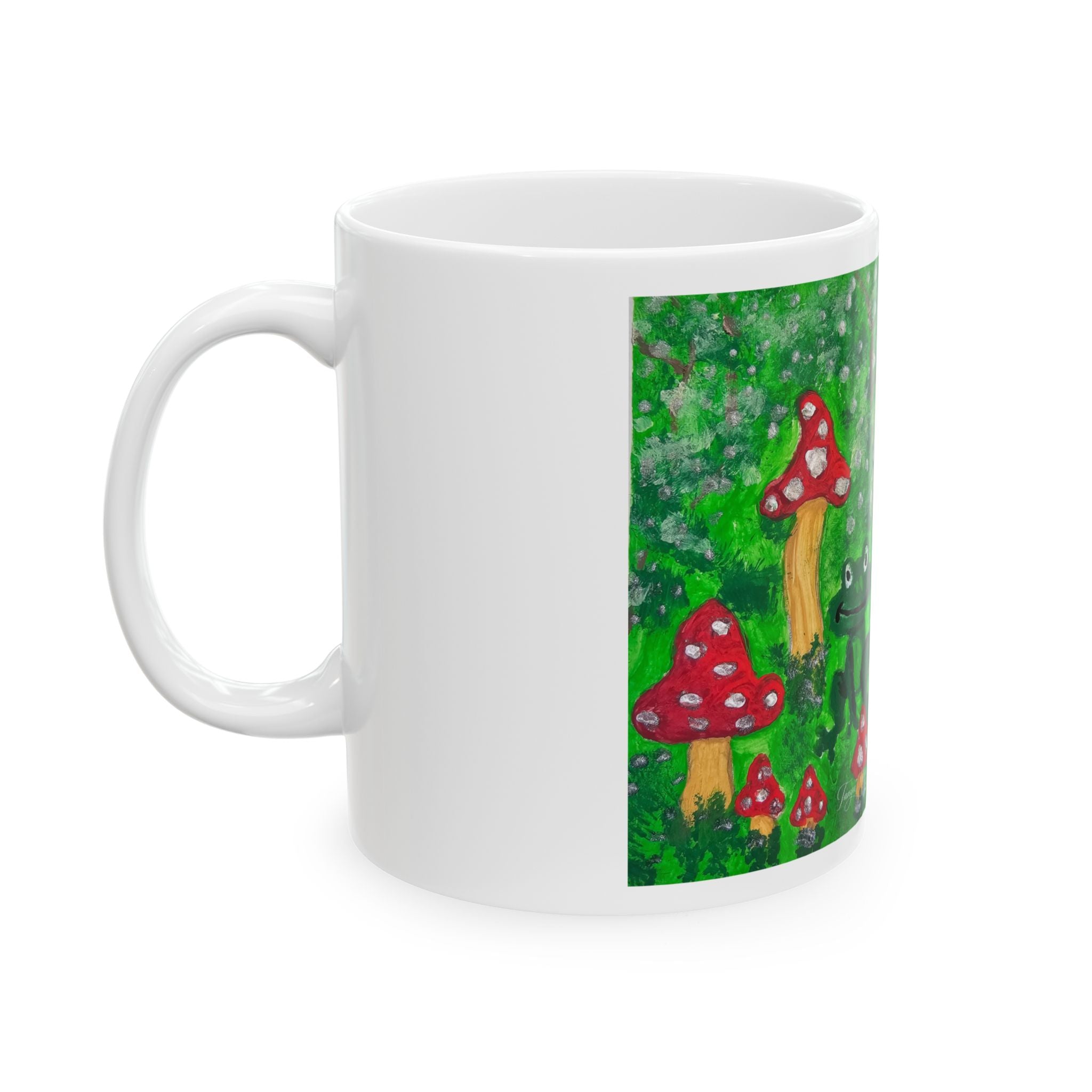 White ceramic mug with side artwork of red mushrooms and green frog, glossy finish