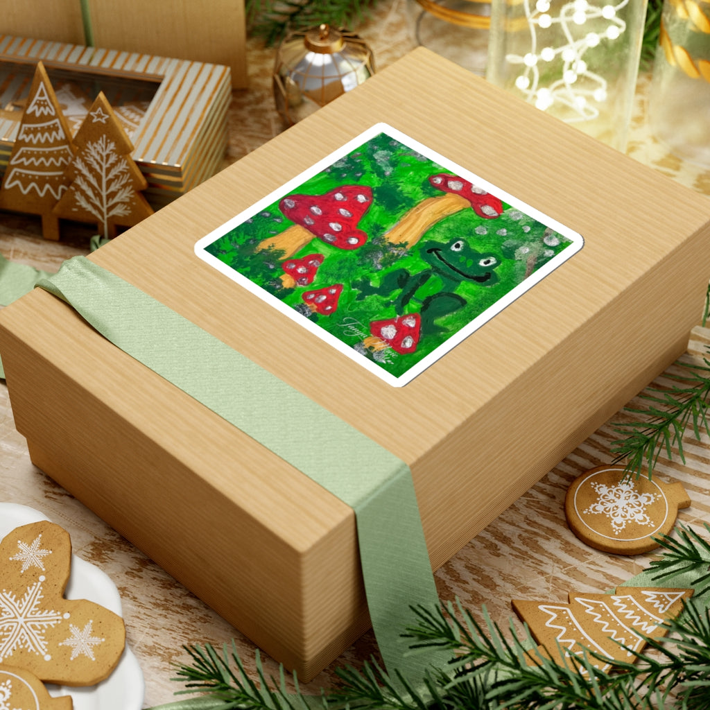 Rectangular kiss-cut sticker with green frog and red toadstools, white border
