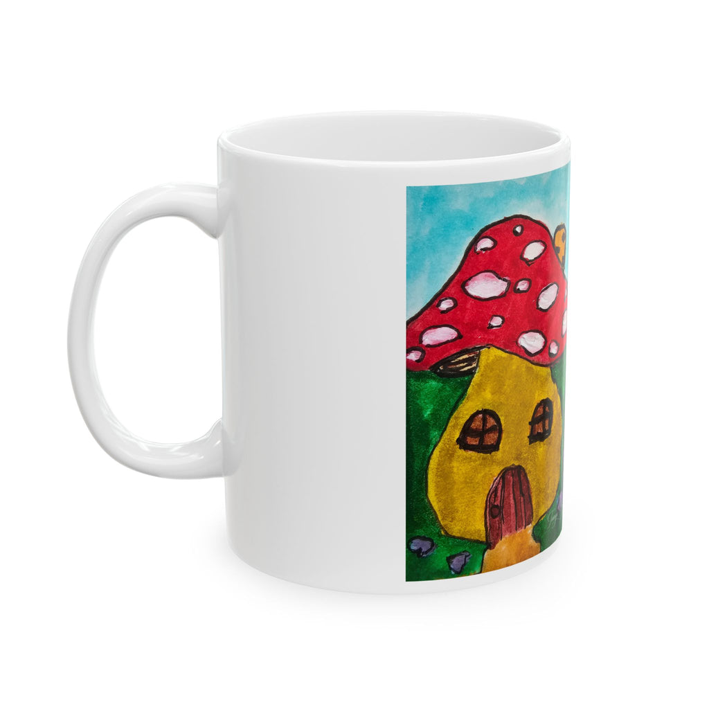 White ceramic mug with handle, showing red mushroom house artwork panel