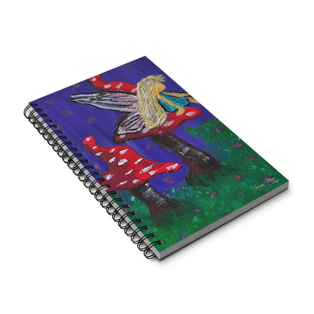 Spiral notebook with colorful fairy and mushroom artwork on a blue cover