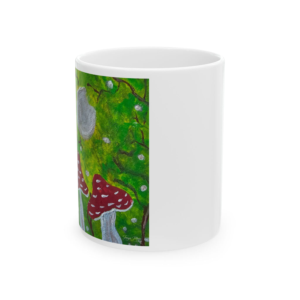 White ceramic mug with green woodland panel featuring red toadstools and gray mushroom cap
