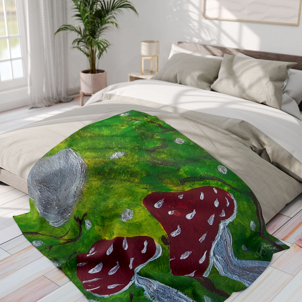 Green fleece blanket with large red mushrooms, gray cap, and scattered specks