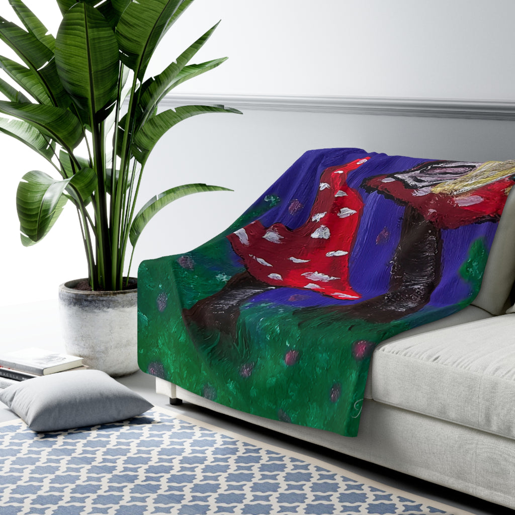 Sherpa throw blanket draped on sofa, fairy tree and red mushrooms over green and blue