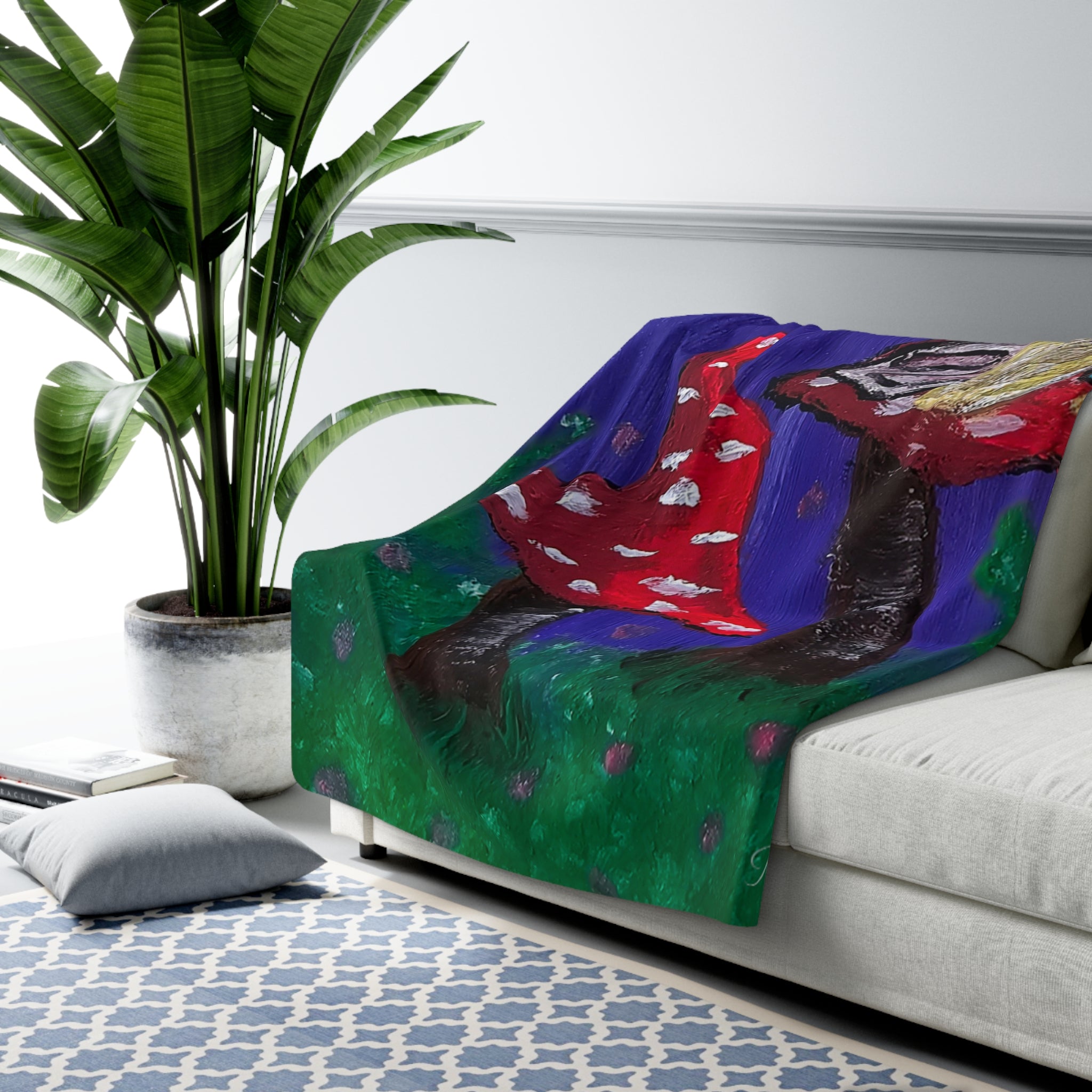 Sherpa throw blanket draped on sofa, fairy tree and red mushrooms over green and blue