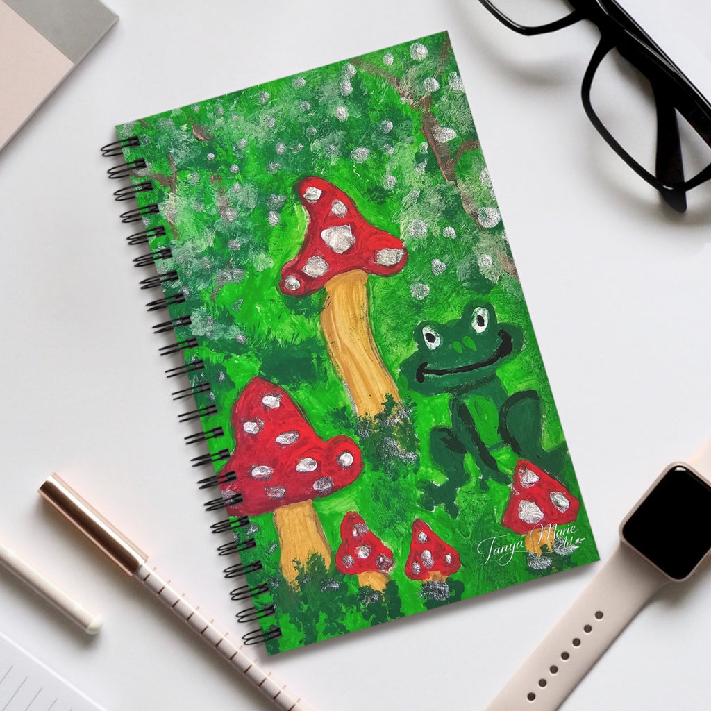 Spiral journal cover featuring mushrooms and frog in a green forest scene, wire binding