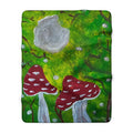 Sherpa blanket square with green foliage background, red mushrooms, and gray trunks with white spots