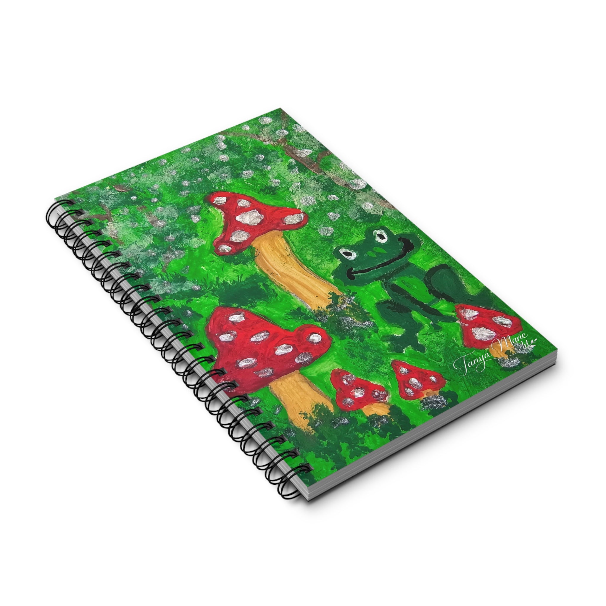 Spiral journal angled view with green illustrated cover and black wire binding rings.