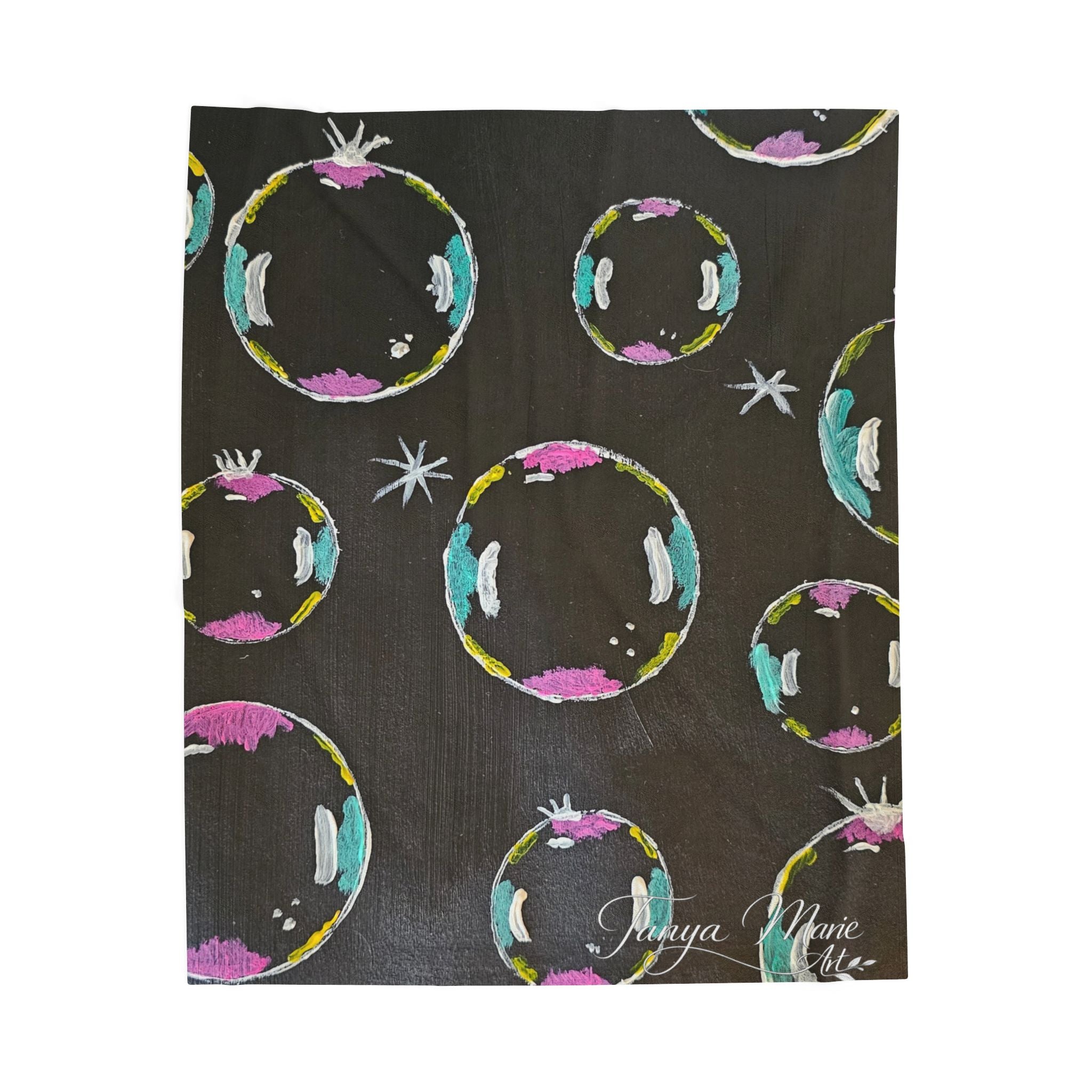 Black plush throw blanket with colorful ring bubble designs and small star accents