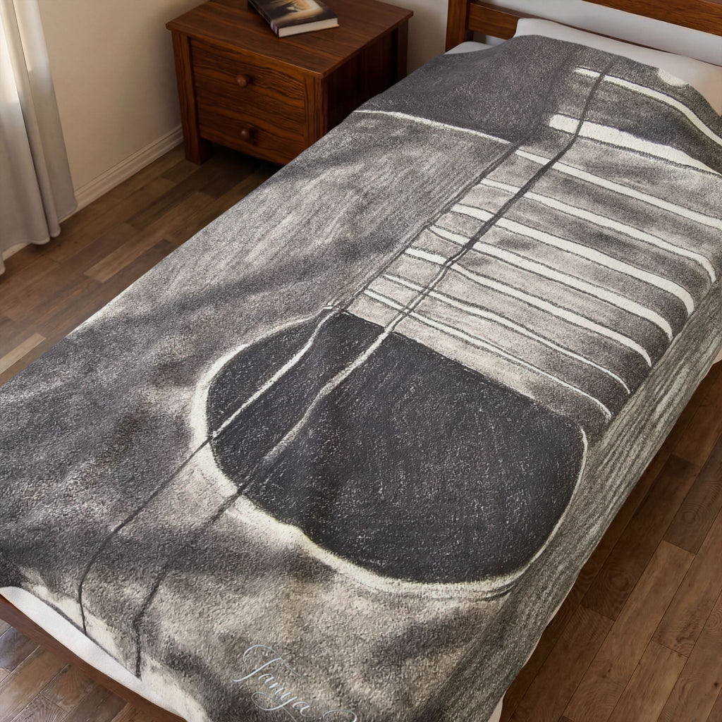 Velveteen plush blanket on bed, large gray guitar sketch with white string lines