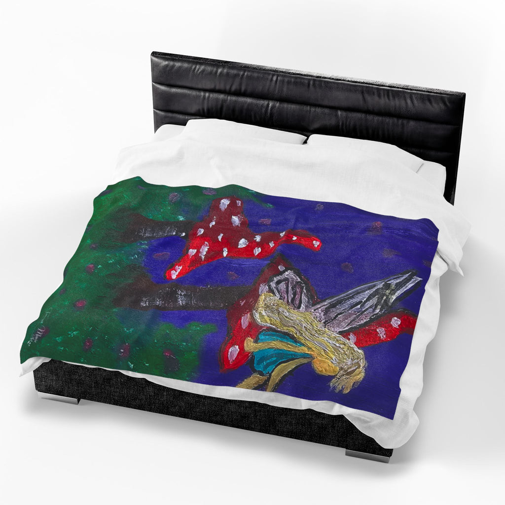 Plush velveteen blanket laid across bed, fairy and red mushroom artwork