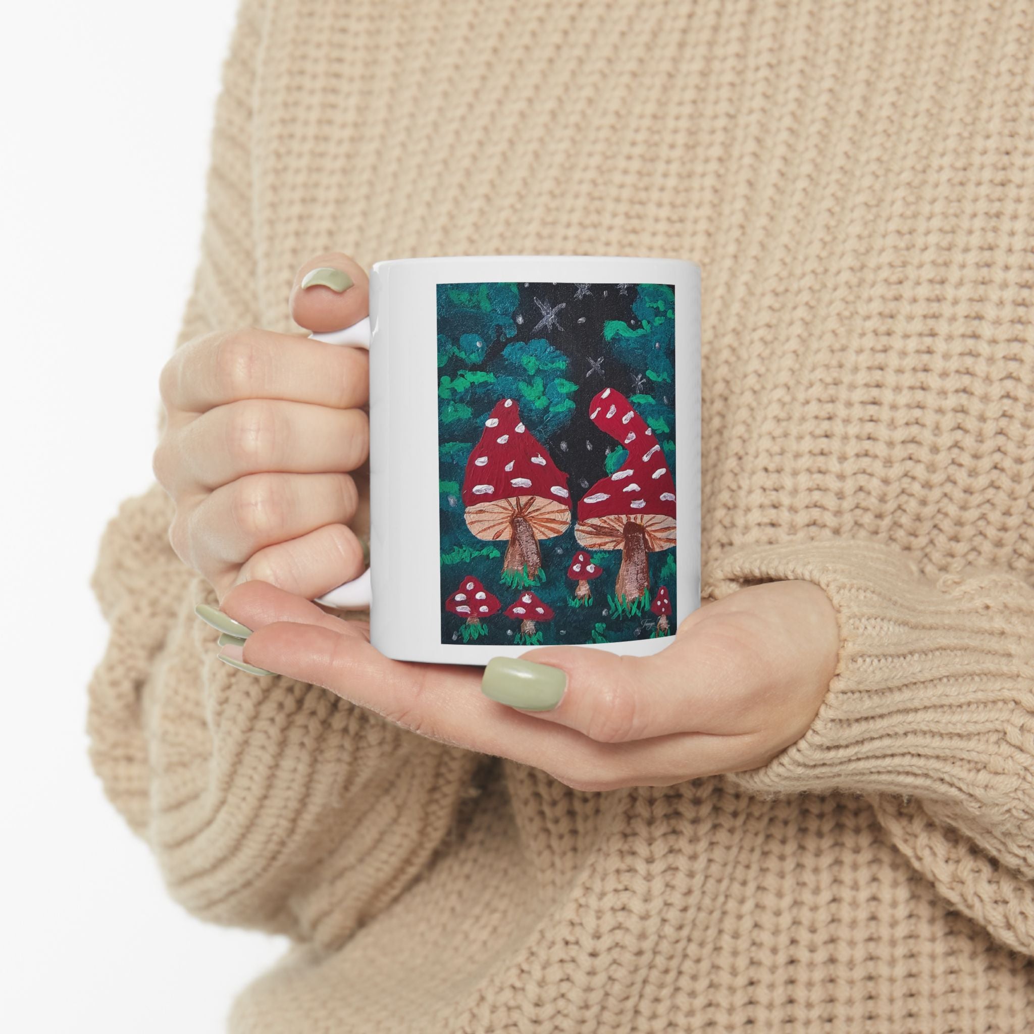 White ceramic mug with red toadstool mushroom forest artwork on the front panel