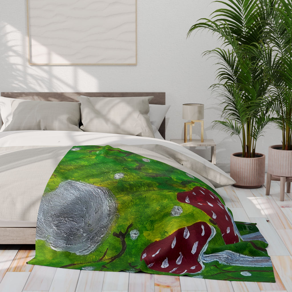 Green fleece blanket with red mushroom caps and gray rocklike moon illustration