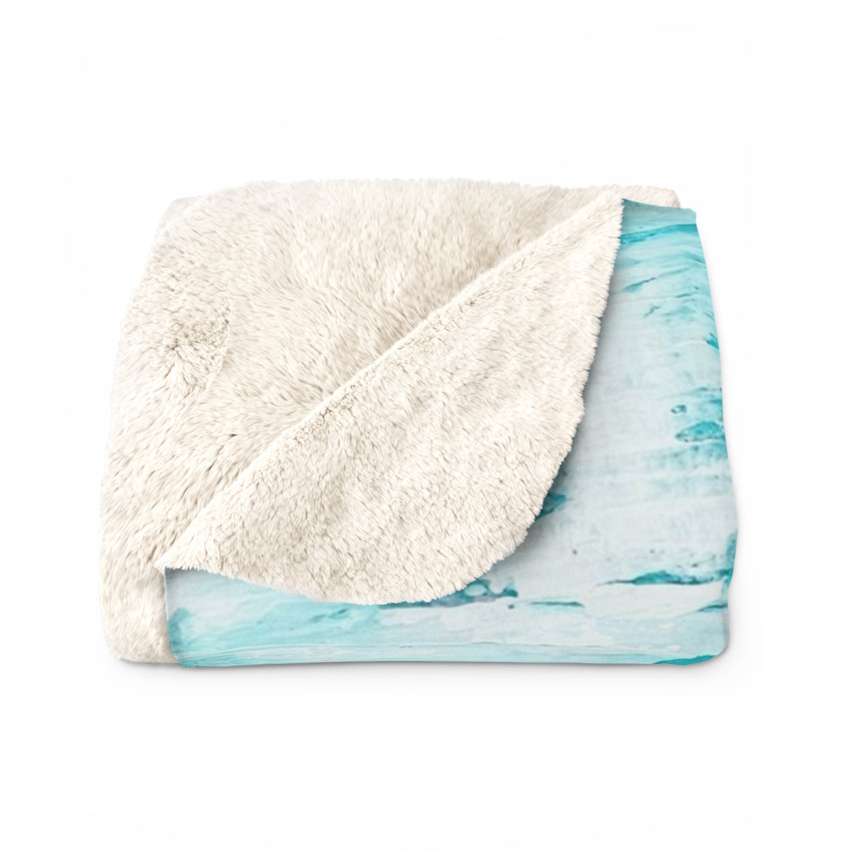 Sherpa blanket folded with off-white fuzzy side and turquoise abstract underside