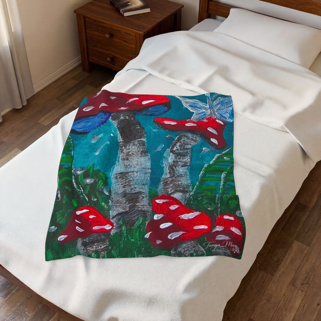 White plush throw blanket with colorful mushroom print patch centered