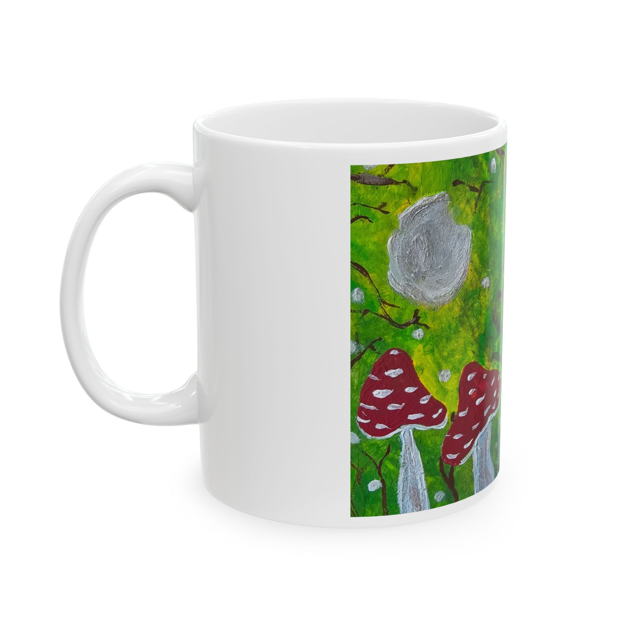 White ceramic mug with green woodland and red toadstool artwork on the front