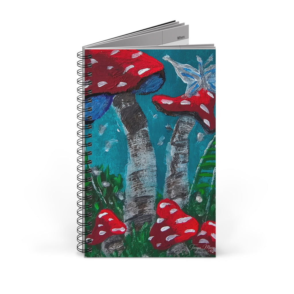 Stacked spiral notebook showing red toadstool cover art and black wire coil binding