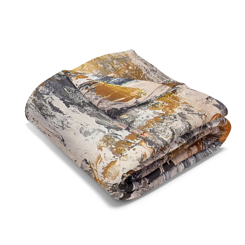 Folded fleece blanket with abstract grey, gold, and black circle artwork