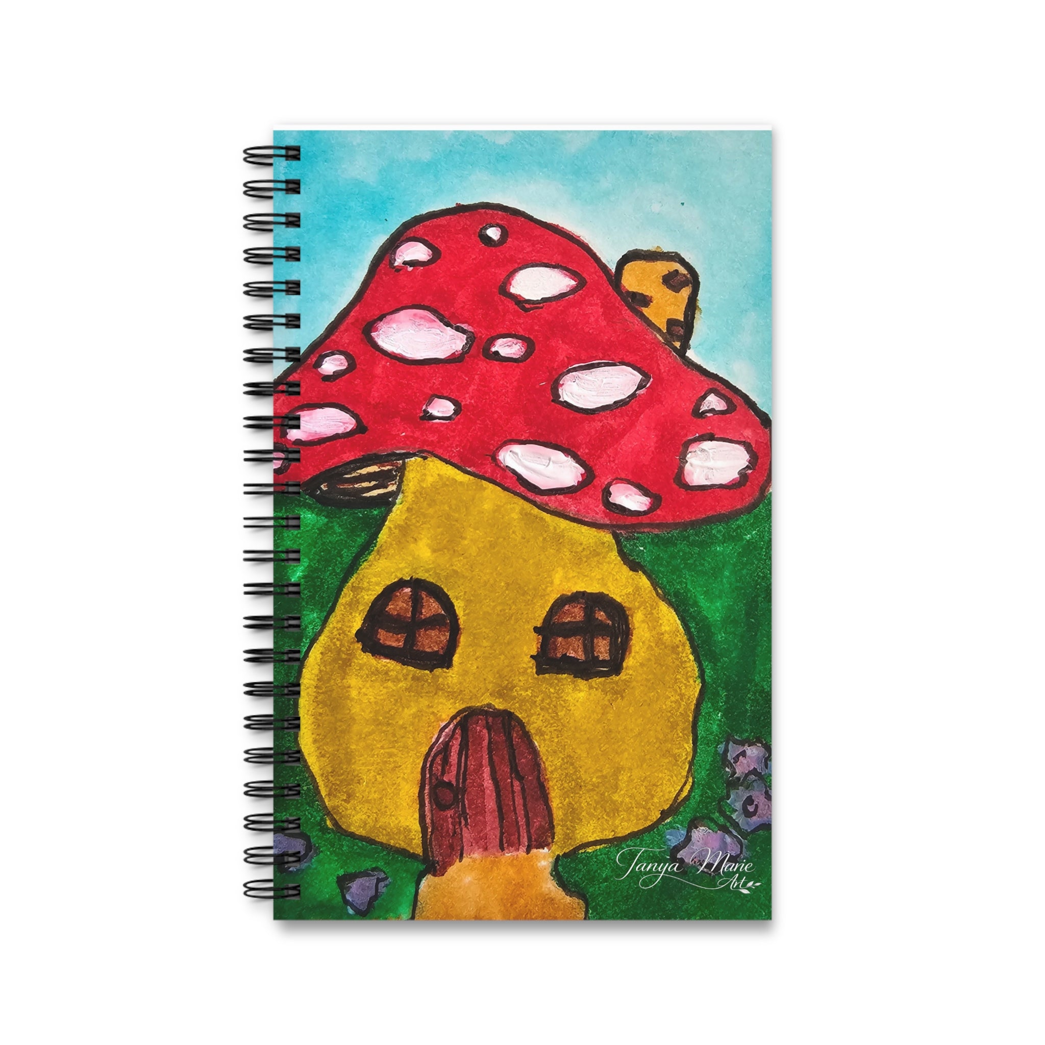 Spiral notebook front cover with red mushroom, yellow cottage, and small door detail.
