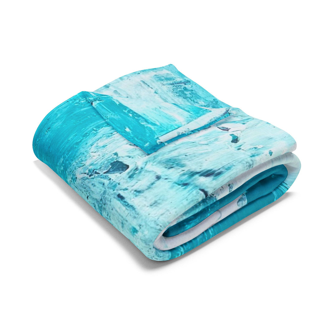 Turquoise abstract fleece blanket folded, splash-streak pattern