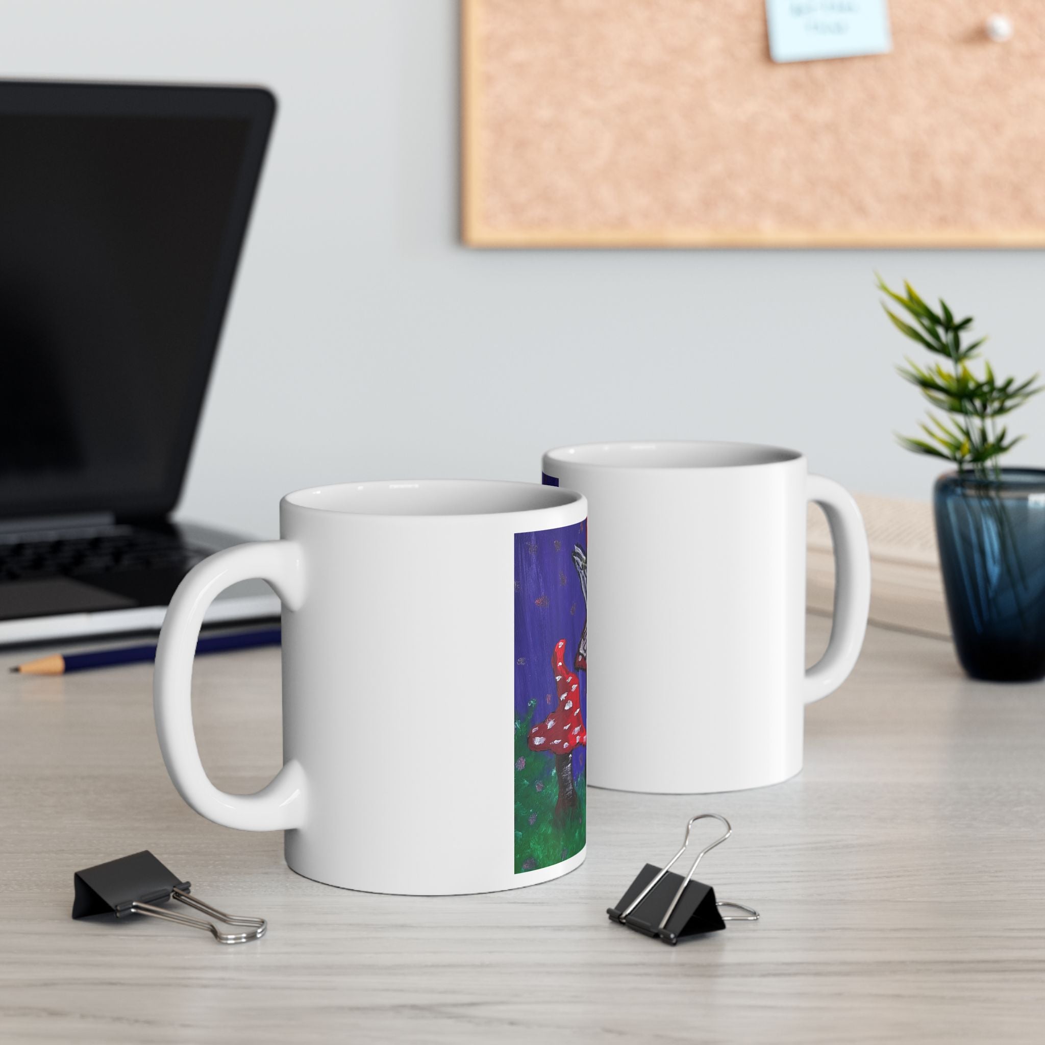 Set of two white ceramic mugs, one showing fairy and toadstool illustration