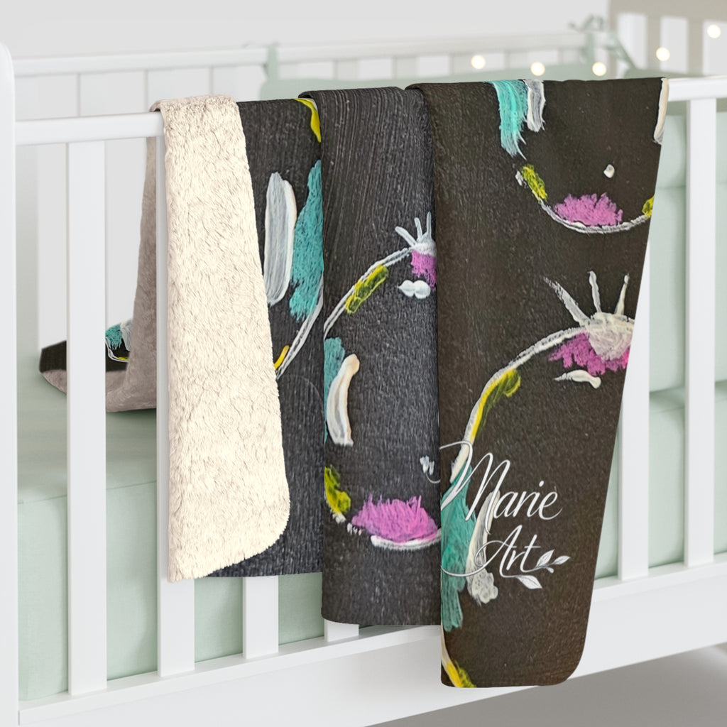 Sherpa fleece blanket draped on crib rail, fluffy white sherpa edge with dark bubble pattern