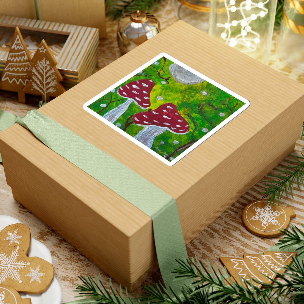 Kiss-cut sticker on gift box top, red toadstools over green moss in a forest scene.