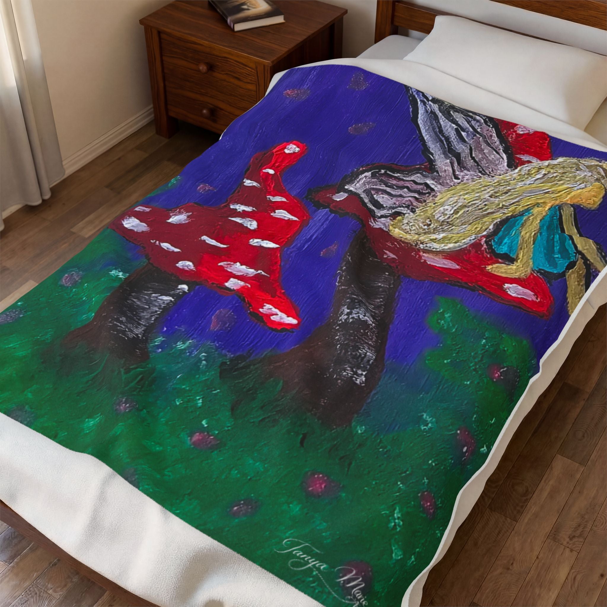 Velveteen blanket plush throw draped on bed, colorful fairy and toadstool artwork