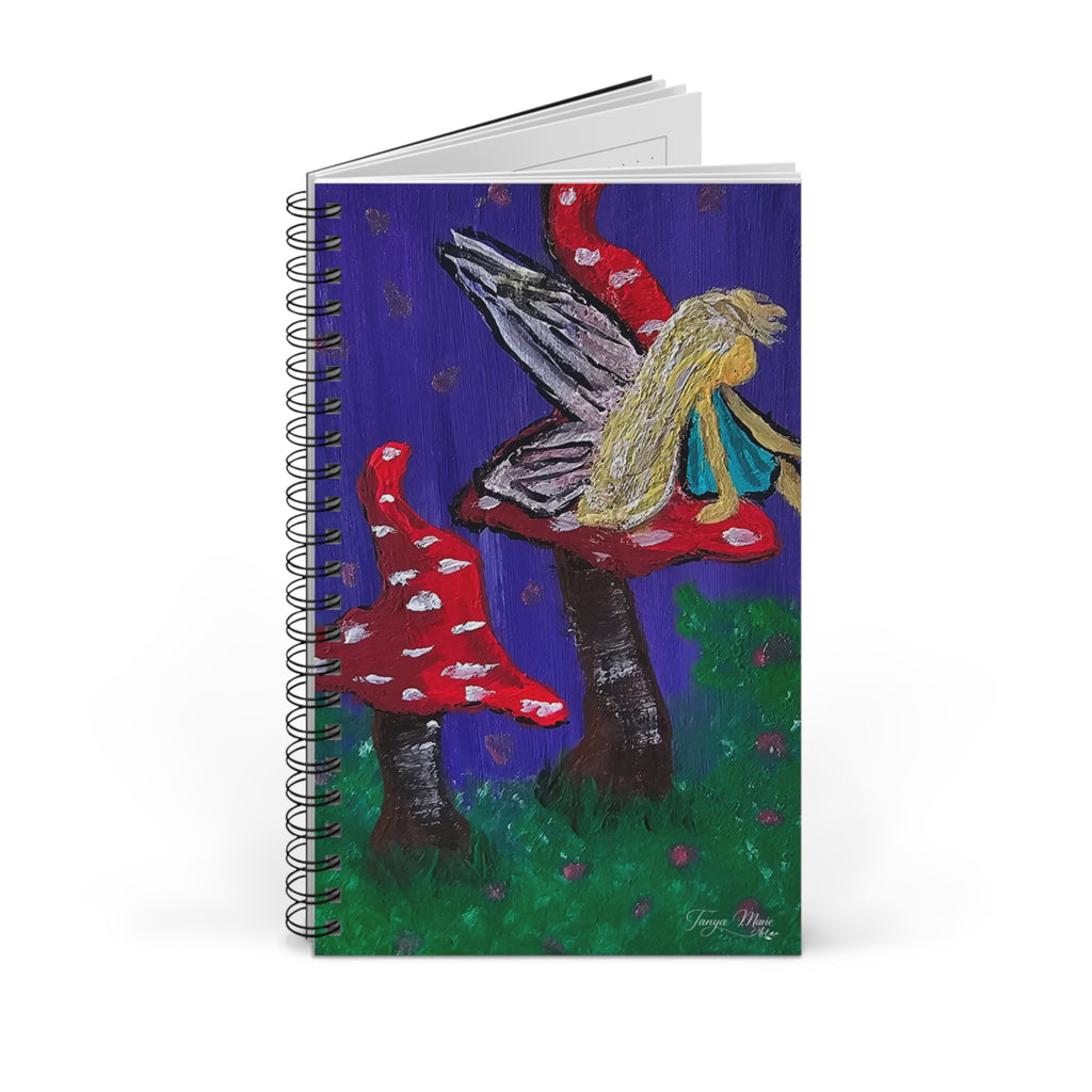 Spiral journal with whimsical fairy and mushroom illustration on a blue cover