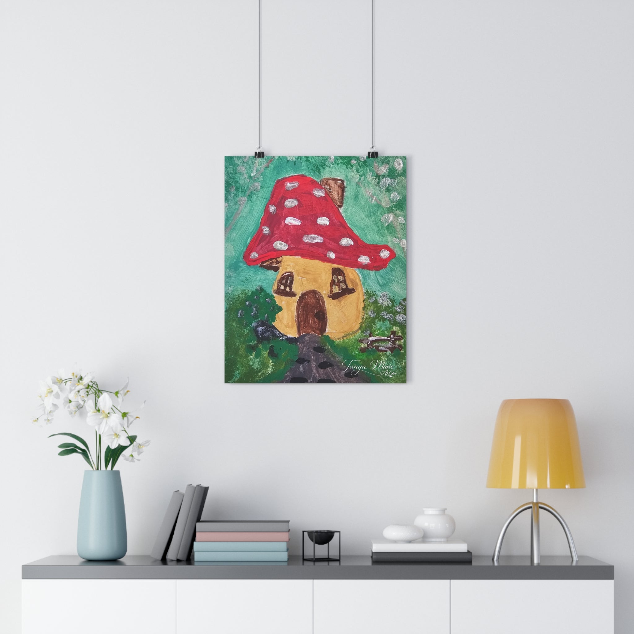 Mushroom cottage wall art print with red polka-dot mushroom house, hanging on two clips