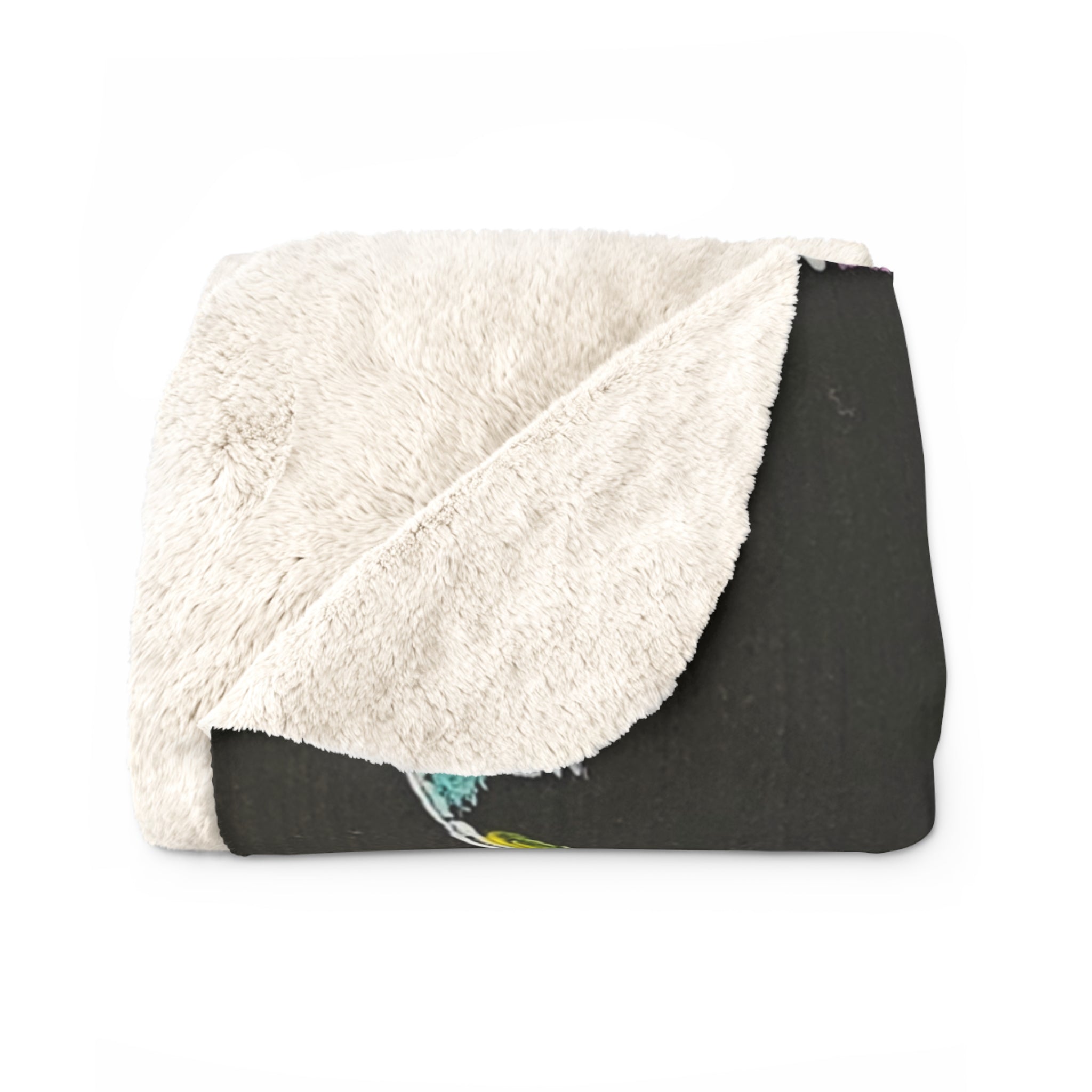 Sherpa fleece blanket folded, showing fluffy white sherpa side over dark printed side