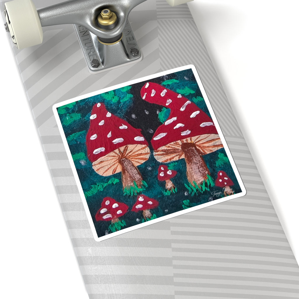Kiss-cut sticker on gray surface: red spotted mushrooms with brown stems and green foliage