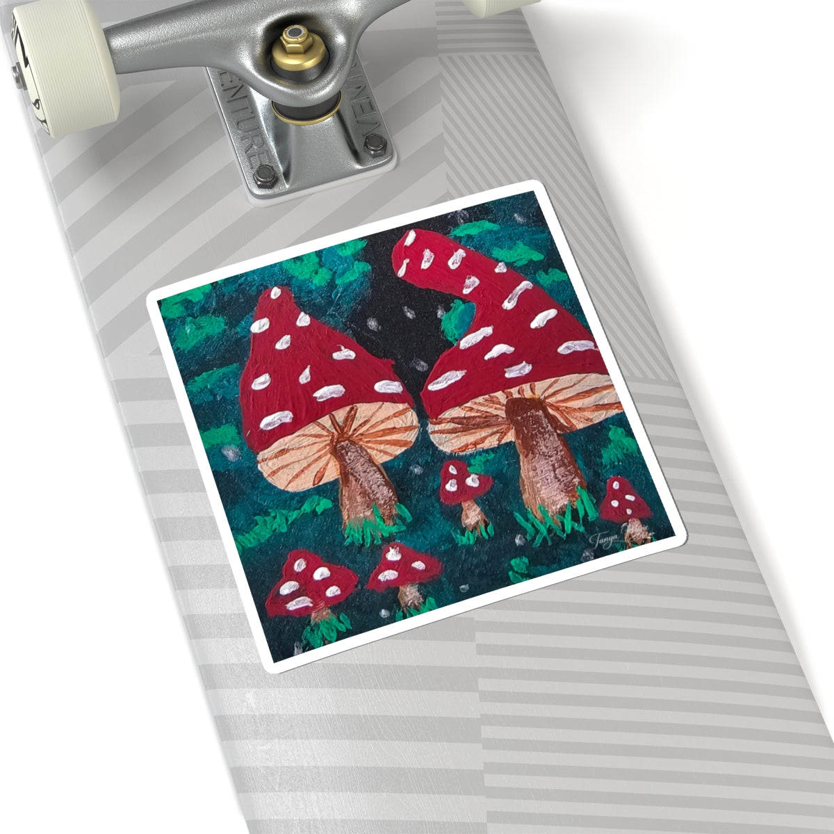 Kiss-cut sticker on gray surface: red spotted mushrooms with brown stems and green foliage