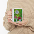 Ceramic mug with green woodland scene and red toadstools, gray mushroom cap artwork